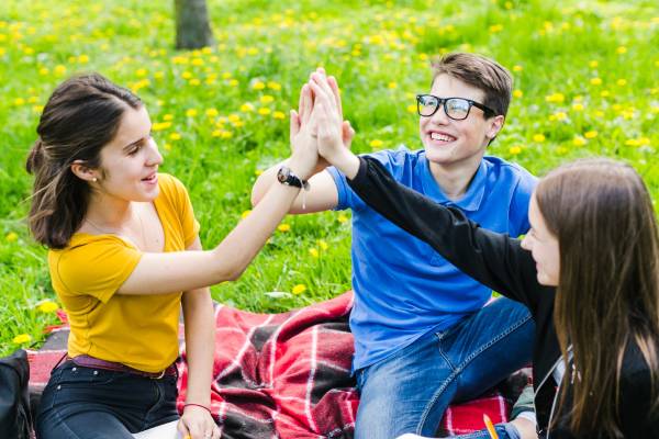 Diverse group of teens enjoying a picnic