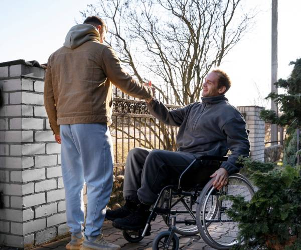 Man in wheelchair getting NDIS Community Access support outdoors