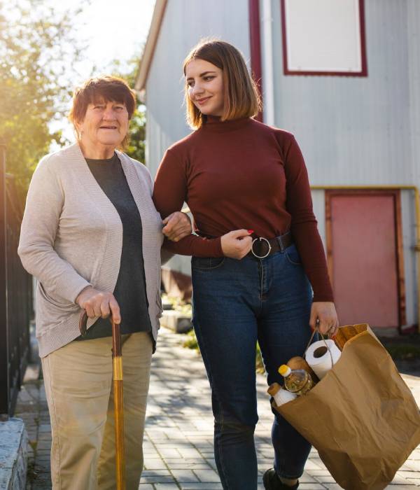 A young man with Down Syndrome does a learning activity with NDIS Supported Independent Living support